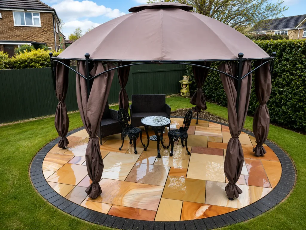 Circular sandstone patio with gazebo in a landscaped Oxford garden